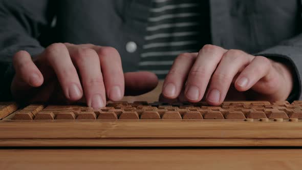 Man Hands Typing on a Keyboard alt