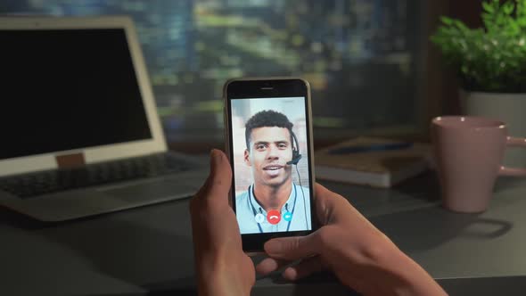 Smartphone Video Calling with Mixedrace Man at Office