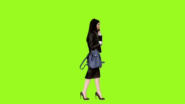 Businesswoman In Heels Walking And Talking On Phone