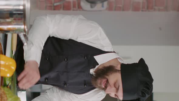 Vertical Video POV of Man Hosting Cooking Show Vlog in Restaurant Kitchen alt