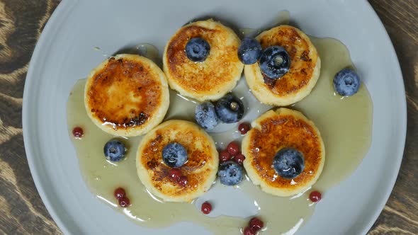 Top View Cottage Cheese Pancakes with Blueberries and Honey in a Bowl