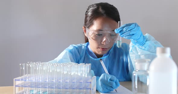 Woman scientist doing research in laboratory alt