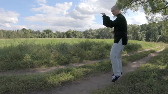 Man Kicks with a Turn. Engaging in Martial Arts in Nature