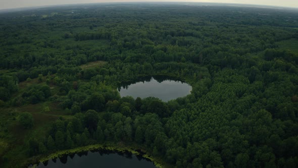 Aerial View of Lakes with Growing Forest Reflection of Sky &amp; Clouds in the Water Nature