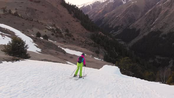 An Aerial View Lady Skier Jumps From a Snow Kicker in the Evening in the Mountains in the Spring alt