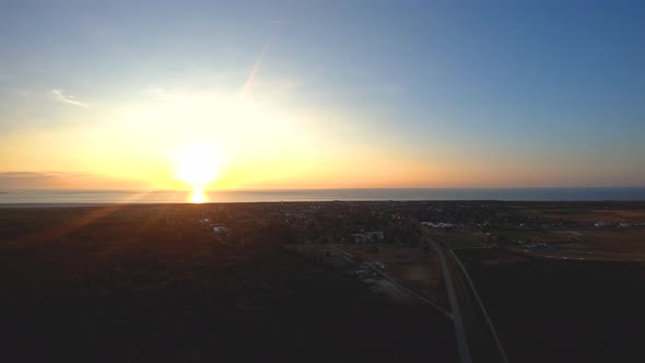 Langeoog, Germany: The City at Sunrise from above by the drone bird's eye view alt