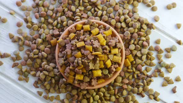 Top View of Rotating Dry Pet Food on a White Table