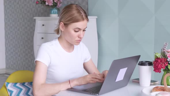 Portrait of beautiful woman sitting in cafe and using laptop for work. alt