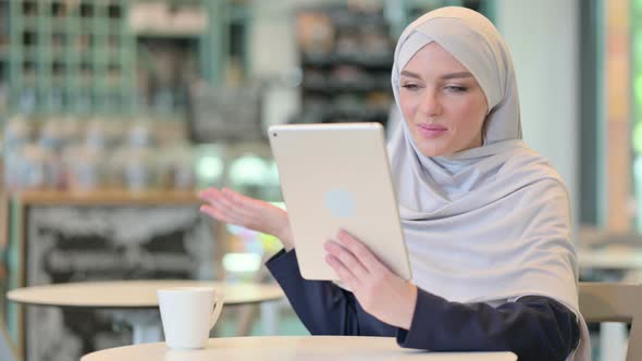 Professional Young Arab Woman Doing Video Call on Tablet  alt