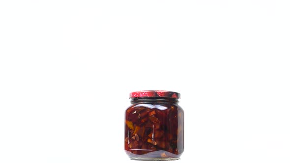 A glass jar of canned apple jam.