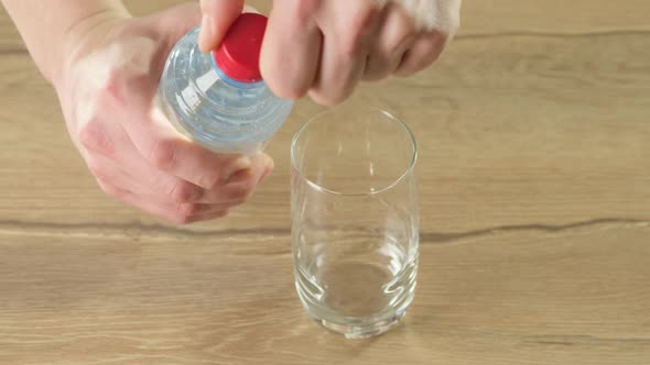 The little man pours clean water into a glass