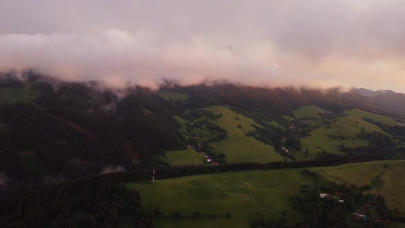 A Hilly Rural Landscape After a Burka Shrouded in Clouds at Dusk in the Golden Hour
