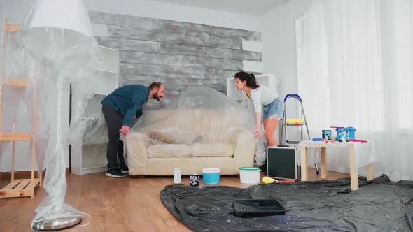 Married Couple Covering Sofa alt