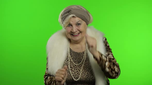 Elderly Stylish Grandmother. Caucasian Woman Claps Her Hands. Chroma Key alt