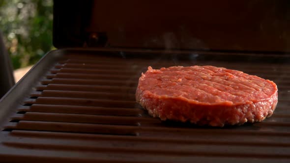 Raw Beef Burger Cutlet Frying on the Grill alt