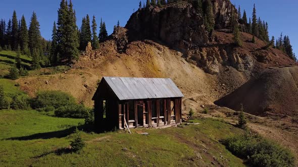 colorado mines mountainside shed aerial flying away by