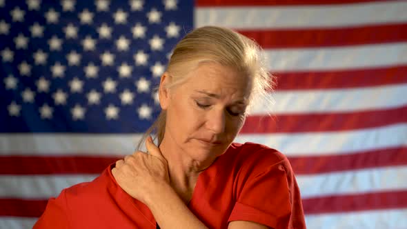 Medium tight portrait of nurse looking overwhelmed and stressed, hands on her head, shaking her head alt
