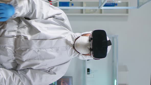 Vertical Video Scientist Researcher in Protection Suit Using VR alt