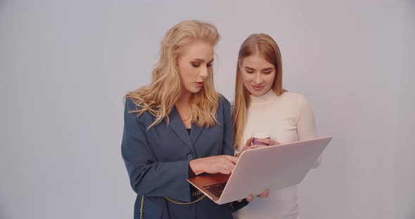 Two Girls On A Laptop Create An Image For A Photo Shoot