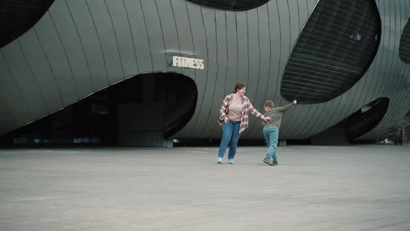 Young Mother and Son are Playing Indulging Trying to Touch Each Other alt