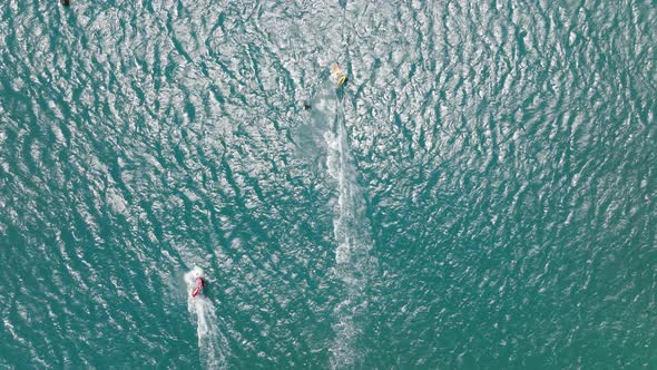 Aerial View of a Windsurfer Pulled Across the Water alt