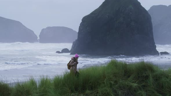 Slow Motion Beautiful Pacific Ocean Coast Traveler Woman Hiking By Grassy Hills alt