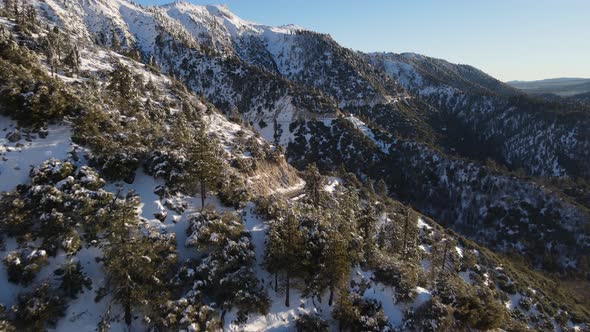 Aerial of a road through the mountains after a snow alt