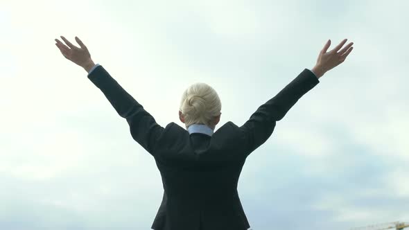 Lady in Formalwear Celebrating Victory and Raising Hands to Sky, Successful Deal