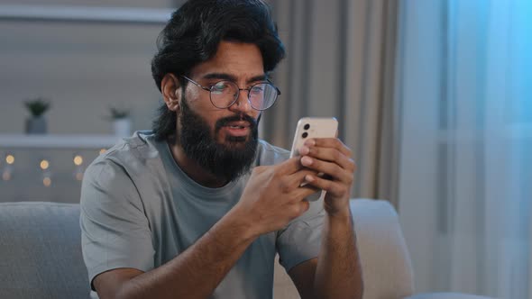 Serious Busy Arabian Indian Man Bearded Male in Glasses Typing Browsing in Smartphone Texting alt