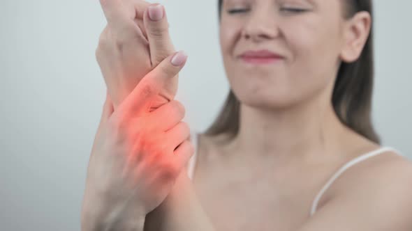 Female Hand Touches Wrist and Tries to Stretch Joint