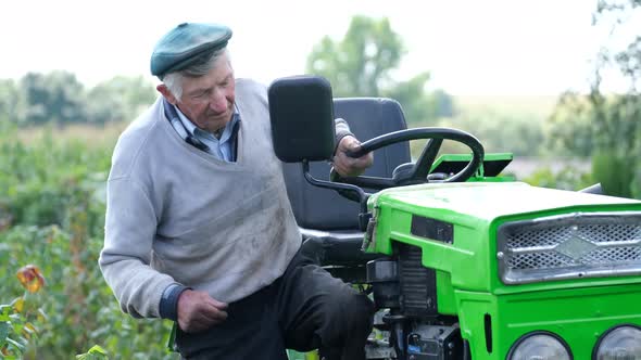A 90Yearold Rural Worker Has Been Working on a Tractor in His Garden alt