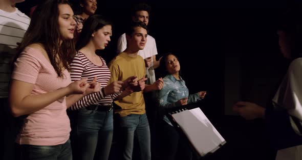 Teenagers rehearsing in a theatre alt