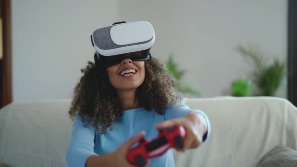 Young African woman playing online video games - Happy gamer having fun with virtual reality alt