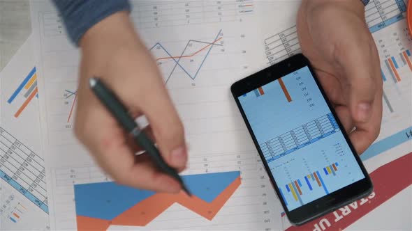 Broker Checking Stock Market Data On Mobile Phone Screen.