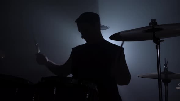 Musician is Playing the Drum Set in the Dark Clouded Studio