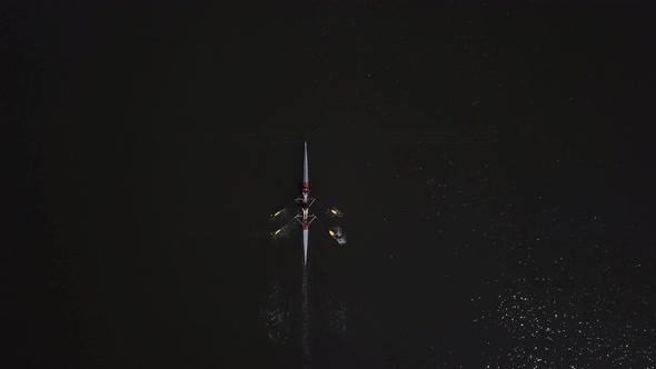 Two People Rowing of Black Water