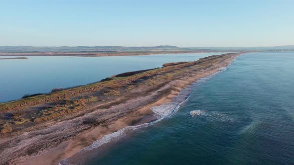 Bird's Eye View of Beach with Sand Grass and Stones Washed By Bay of Black Sea and Lake Under Sky in alt