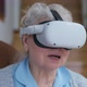 Closeup Portrait of Happy Senior Woman in VR Googles Singing and Smiling at Home in Living Room