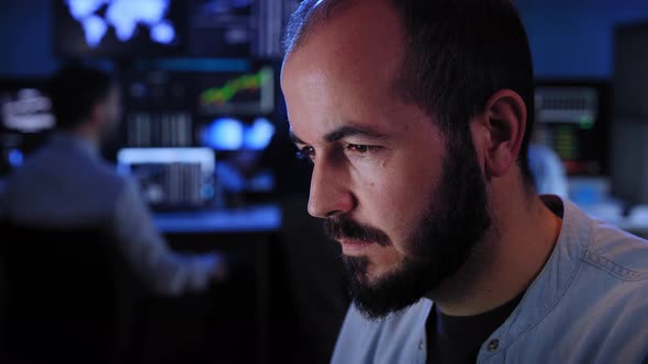 Team of Stockbrokers are Having a Conversation in a Dark Office with Display Screens alt