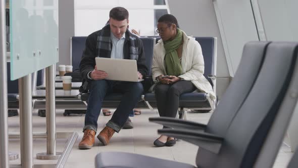 Businessman and businesswoman meeting at airport