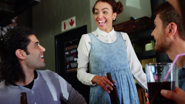 Friends toasting drinks together in restaurant alt