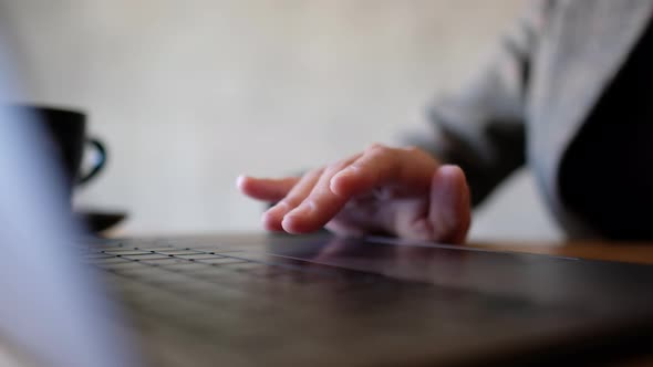 Closeup a woman working and touching on laptop computer touchpad on the table