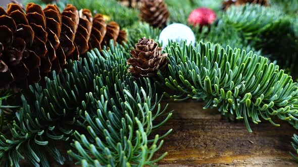Abies nobilis branch with cones and Christmas balls alt