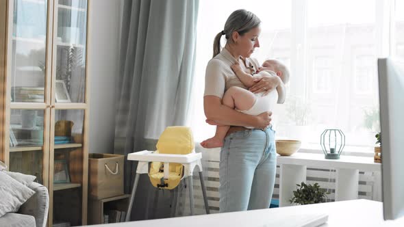 Mother Rocking Child in Arms alt