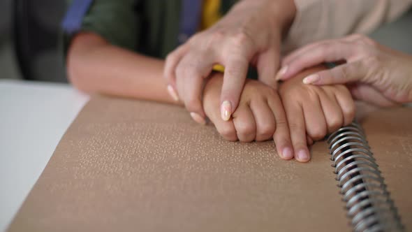 Handicapped Child Learns to Read Braille Female Teacher Helps Blind Boy Move His Fingers Through the alt