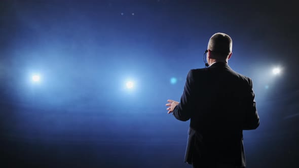 Showman. Middle Age Male Entertainer, Presenter or Actor on Stage. Arms To Sides alt