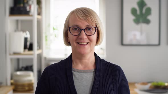 Video portrait of happy senior woman at home. Shot with RED helium camera in 8K. alt