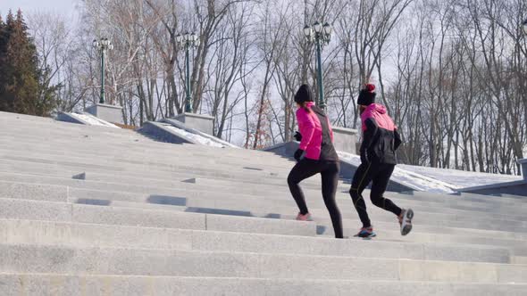 Fit People Jogging on Staircase on Winter Day alt