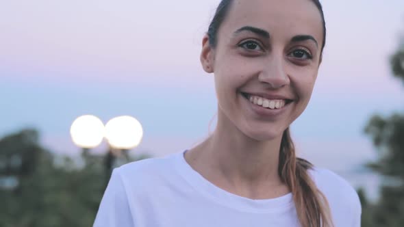 Close Up Portrait of a Young Beautiful Woman on the Evening Sky Background. Young Pretty Smiling alt