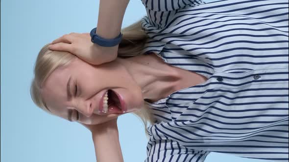 Scared Desperate Woman Screaming and Covering Ears on Blue Background alt